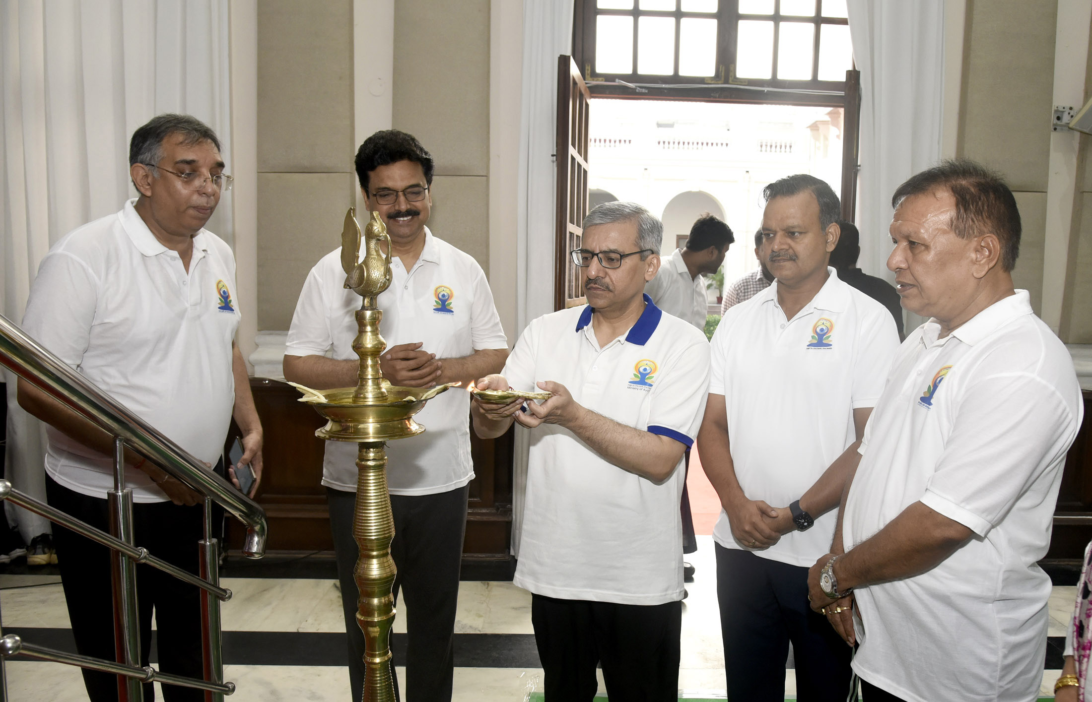 Dr. Vineet Joshi lighting the lamp during the 11th International Day of Yoga celebrations